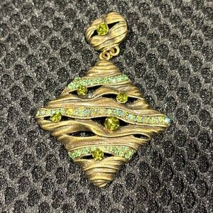 Wavy Textured Gold-Tone Pendant with
Sparkling Green Gems